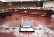 FBI Boss Cries During Hearing – Caught Lying! Conference microphone on a podium in a courtroom