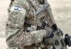 soldier in camouflage holding a rifle