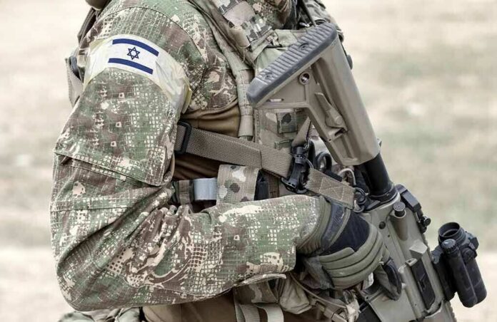 shutterstock_1917131027-1 soldier in camouflage holding a rifle