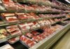 supermarket meat section with packaged cuts in refrigerated shelves