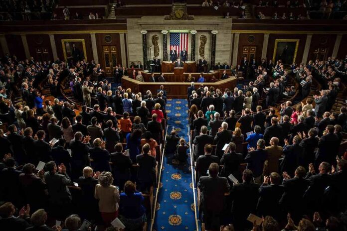 shutterstock_218485888 Legislative chamber audience stands and applauds