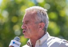 Robert F. Kennedy Jr. speaking into a microphone outdoors