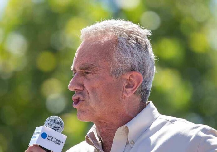 Robert F. Kennedy Jr. speaking into a microphone outdoors