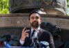 Zohran Mamdani speaking at an outdoor press conference