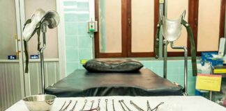 Gynecology exam room with table and surgical instruments