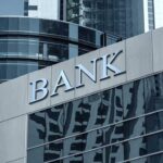 Bank building facade with large sign and glass windows