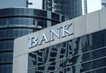 Bank building facade with large sign and glass windows