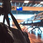 FBI Nabs Alleged China Spy At LAX duffel bag in foreground at empty airport gate seating