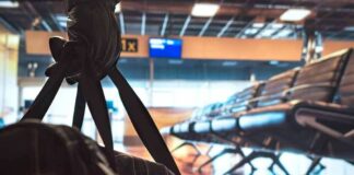 duffel bag in foreground at empty airport gate seating
